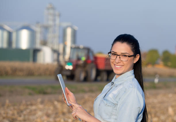 istock Agronomist with tablet and grain silos 860575390