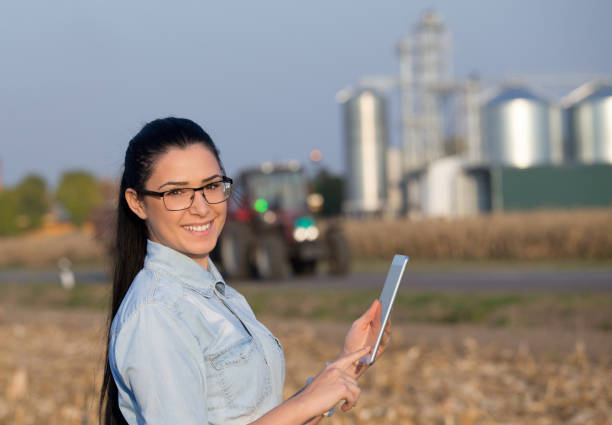 istock Agronomist with tablet and grain silos 860575488