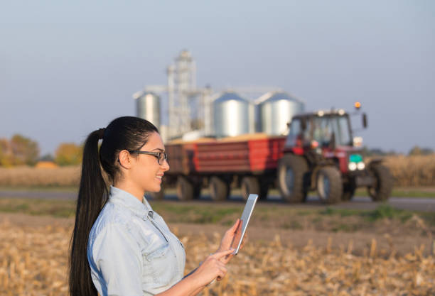 istock Agronomist with tablet and grain silos 860577644