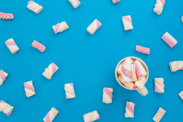 istock Colorful marshmallow with cappuccino mug on pink background. Flat lay, top view 860577996