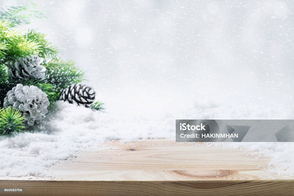 Fir tree,pine branch,snow on wooden table. Fir tree,pine cones,snow on wooden table.Christmas ornament decoration concepts background Table Stock Photo