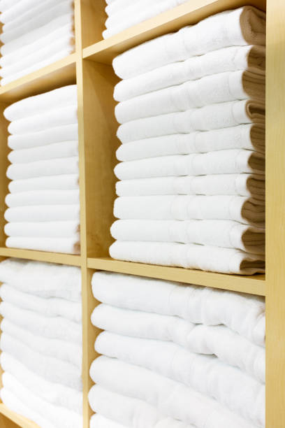 istock Fresh White Hotel Towels Folded and Stacked on a Shelf 860586822