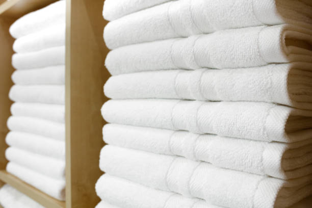 istock Fresh White Hotel Towels Folded and Stacked on a Shelf 860586890