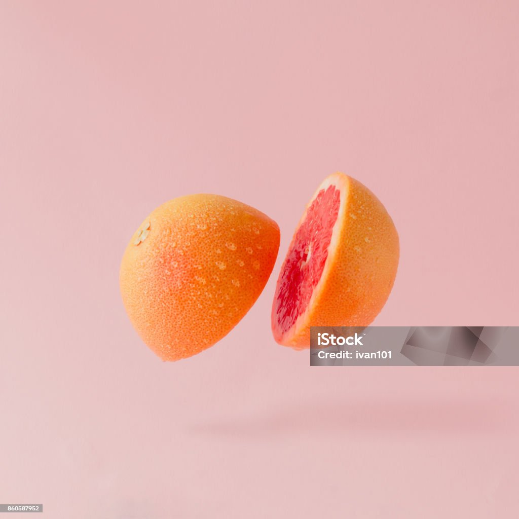 Grapefruit sliced on pastel pink background. Minimal fruit concept. Fruit Stock Photo