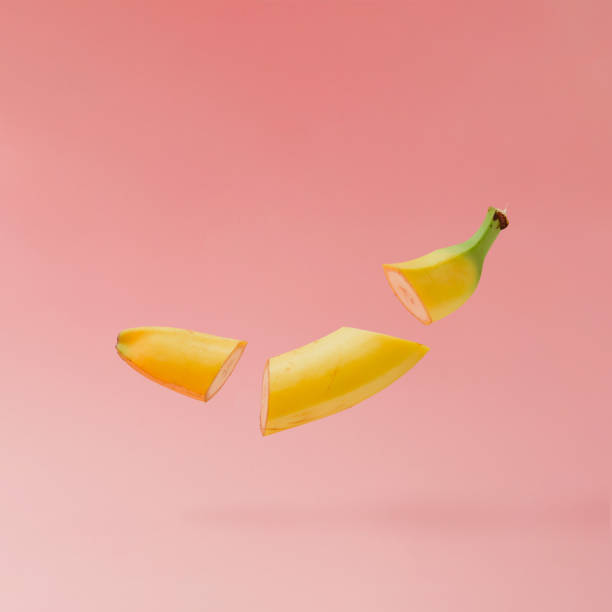 istock Banana sliced on pastel pink background. Minimal fruit concept. 860588068