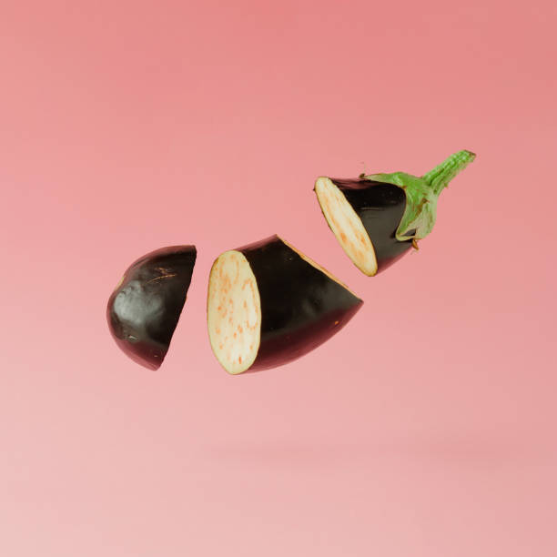 istock Eggplant sliced on pastel pink background. Minimal fruit concept. 860588146