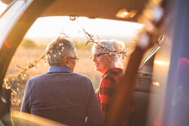 istock Senior couple outdoors with car 860590832