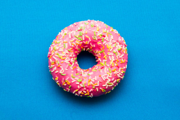 istock The donut in the glaze on a blue background 860590952
