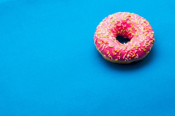 istock The donut in the glaze on a blue background 860591332