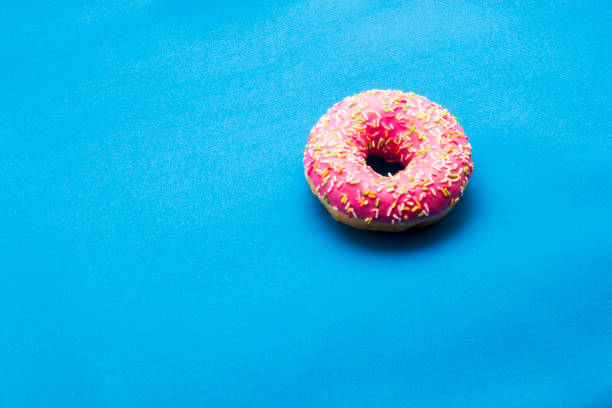 istock The donut in the glaze on a blue background 860591652
