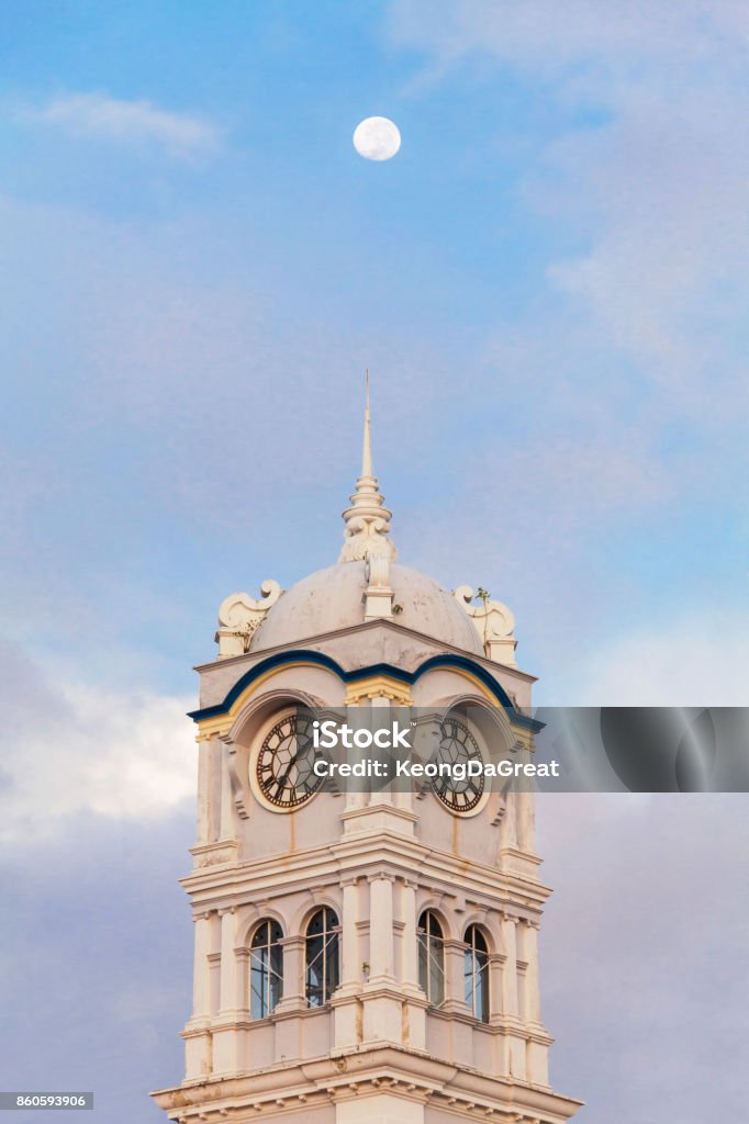 Close up view of clock tower with blue sky in George Town Penang Architecture Stock Photo