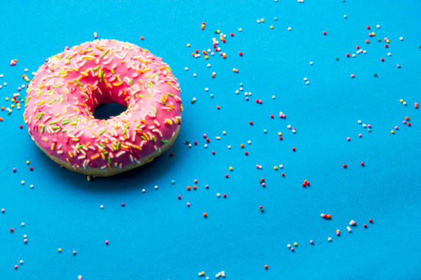 istock The donut in the glaze on a blue background 860594436