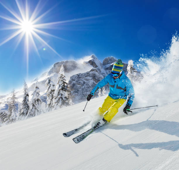istock Young man skier running down the slope in Alpine mountains 860594590
