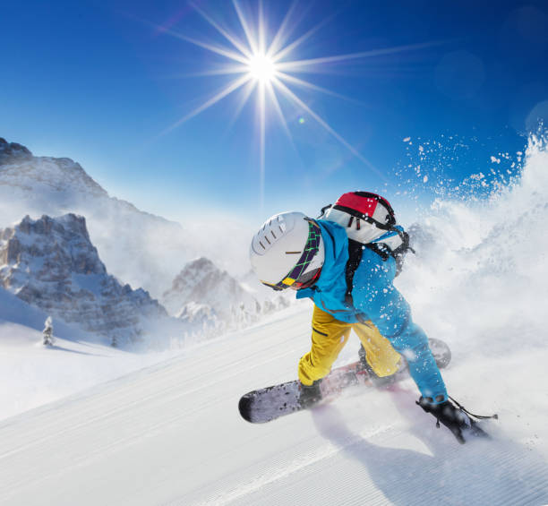 istock Young man snowboarder running down the slope in Alpine mountains 860594772