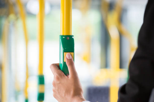 Close-up Of A Businesswoman's Hand Pressing Stop Button On Bus