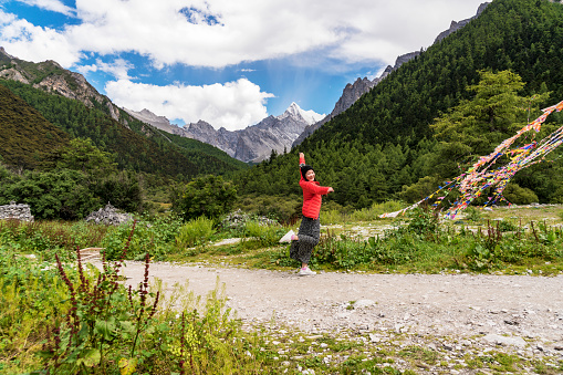 A female traveller was in the canyon,Daocheng County, Sichuan province, China.