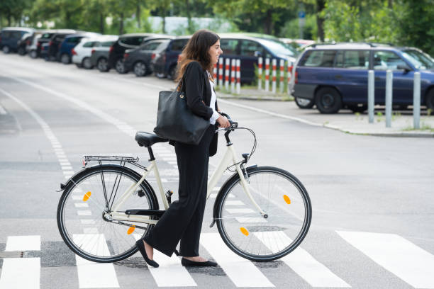 istock Smiling Businesswoman With Handbag Commuting On Bicycle 860605506
