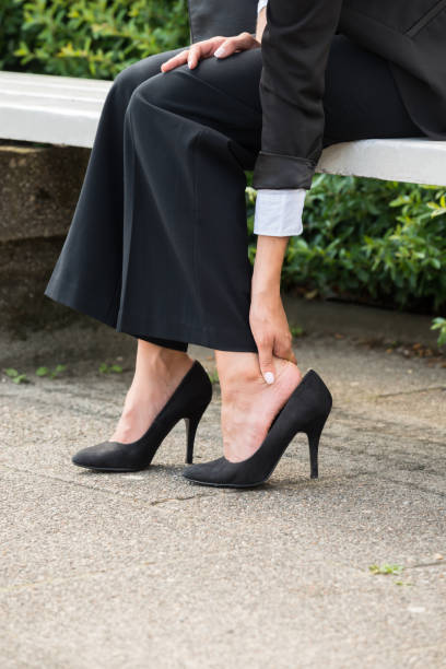 istock Businesswoman's Hand Removing High Heels 860606152