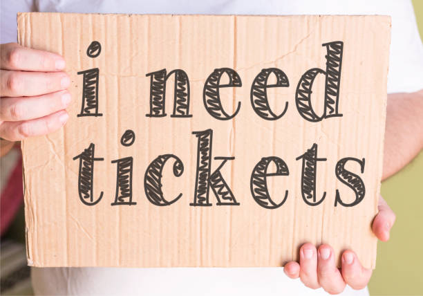 istock i need tickets on cardboard in hands man 860609306