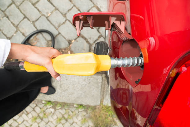 istock Businesswoman's Hand Refueling Her Car 860609928