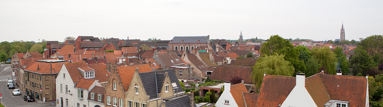Panorama of the central part of Bruges. Top view on the background of the red roofs of the city. Belgium