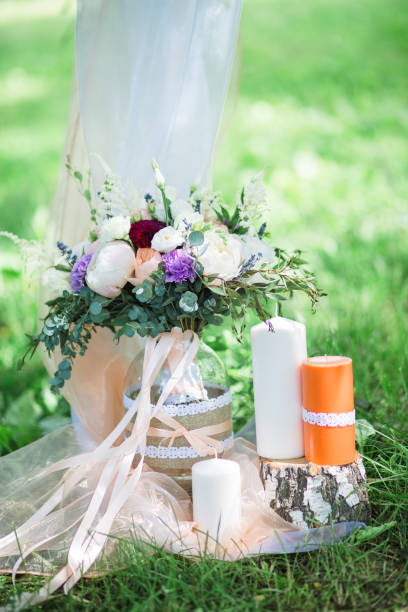 istock Wedding bouquet with candles on green grass 860610228