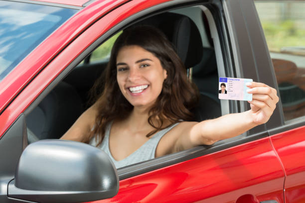 istock Woman Showing Her Driving License 860610486