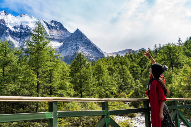 A female traveller was in the canyon,Daocheng County, Sichuan province, China.