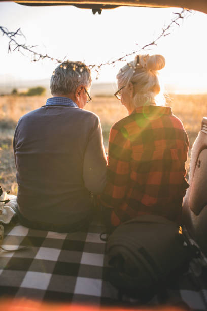 istock Senior couple outdoors with car 860611522