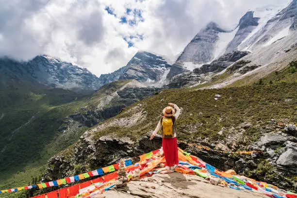 A female traveller was in the canyon,Daocheng County, Sichuan province, China.