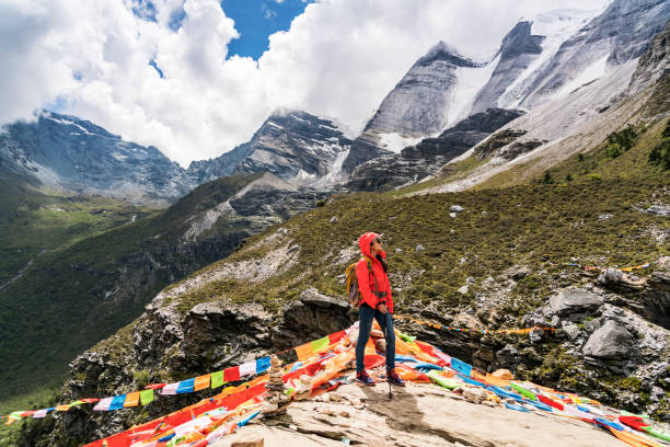 A female traveller was in the canyon,Daocheng County, Sichuan province, China.