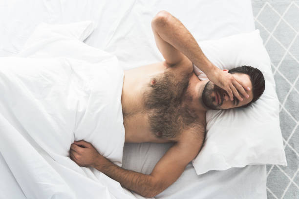 istock Tired young man waking up early in morning 860615000