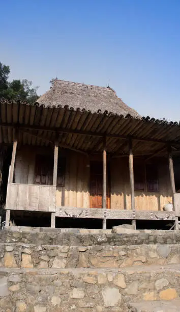 Front of wooden house in Bena a traditional village with grass huts of the Ngada people in Flores near Bajawa, Indonesia.