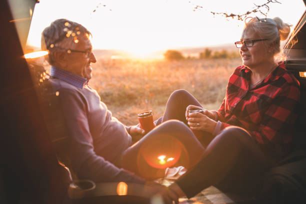 istock Senior couple outdoors with car 860616540