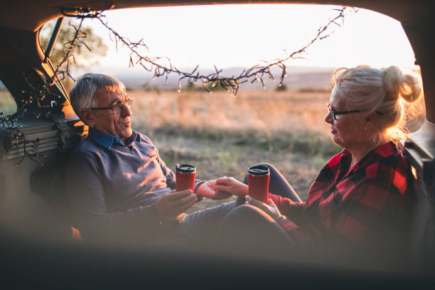 istock Senior couple outdoors with car 860617680