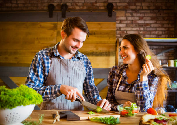 Young smiling couple cooking together