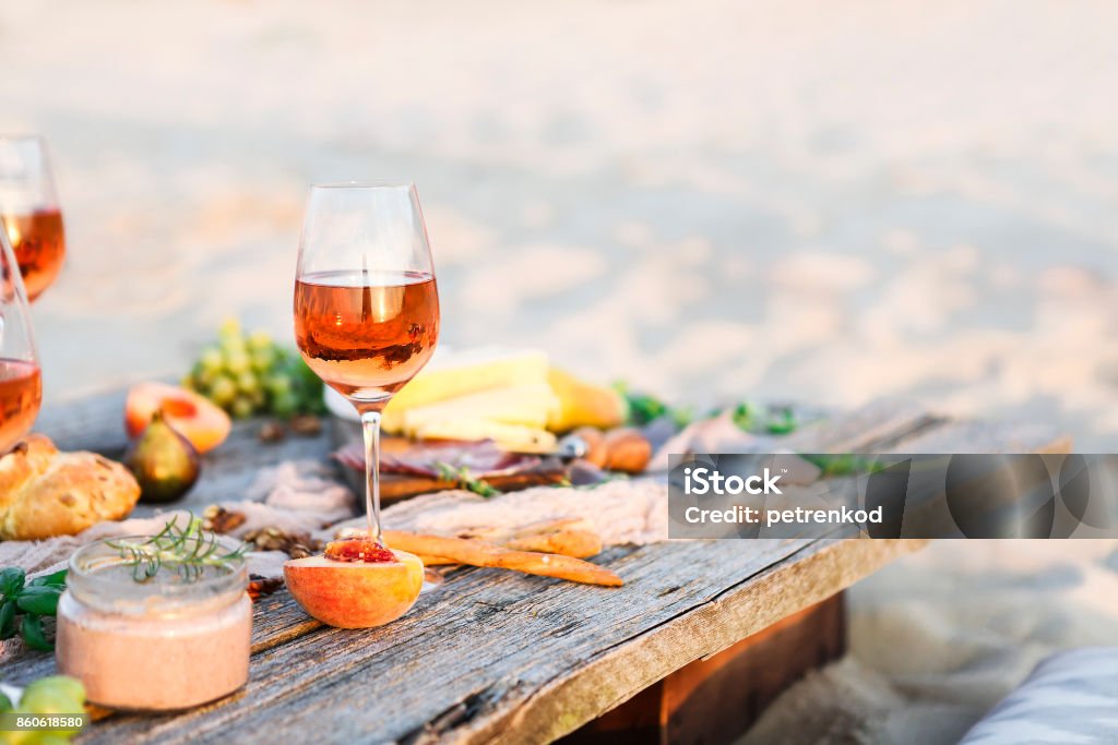 Glass of rose wine on rustic table Glass of rose wine on rustic table. Food and drink background Beach Stock Photo
