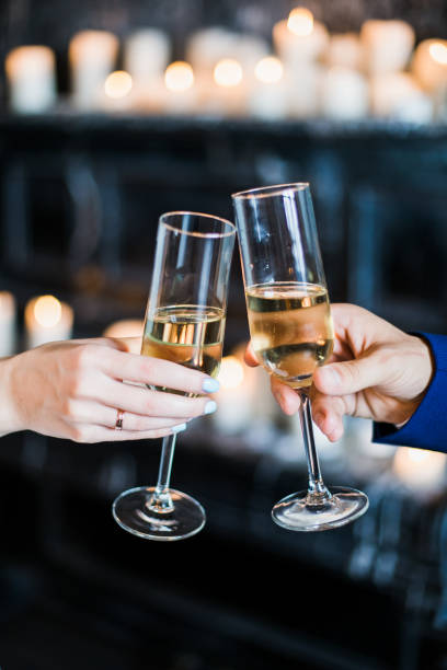istock bride and groom holding glasses with champaign 860621074