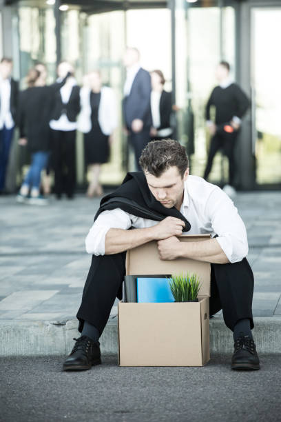istock Fired businessman sitting on street 860624536