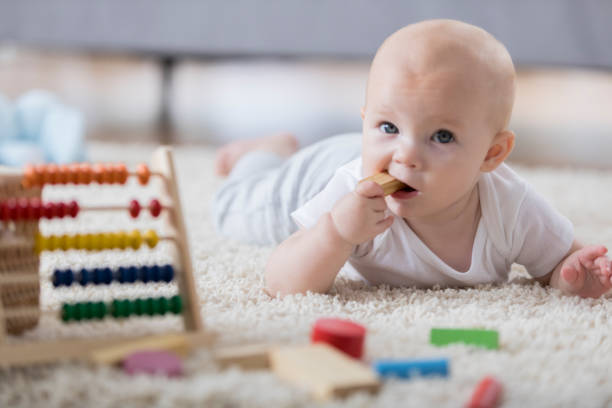 istock Baby chewing on toy 860628472