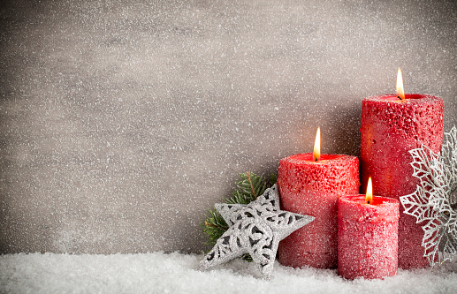 Three red candles on gray background, Christmas decoration. Advent mood.