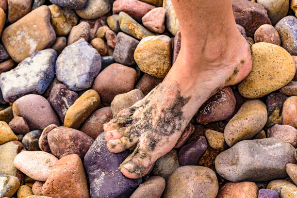 High angle detail view woman foot at rocky ground