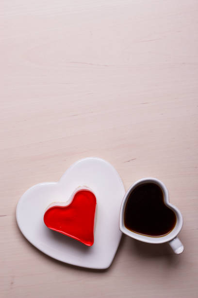 istock Heart shaped coffee cup and cake on wood surface 860634866