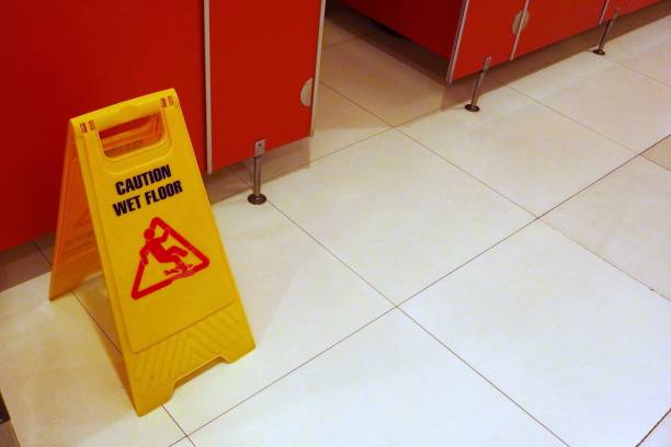 Yellow Caution wet floor sign in public toilet