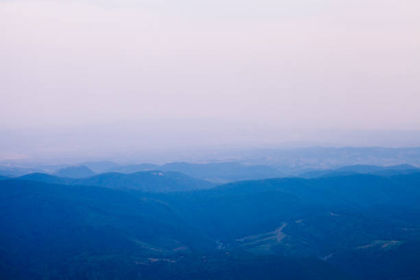 Layers of blue mountains on morning light.  Semenic-Cheile Carașului National Park in Romania. Blue misty morning. Horizontal image