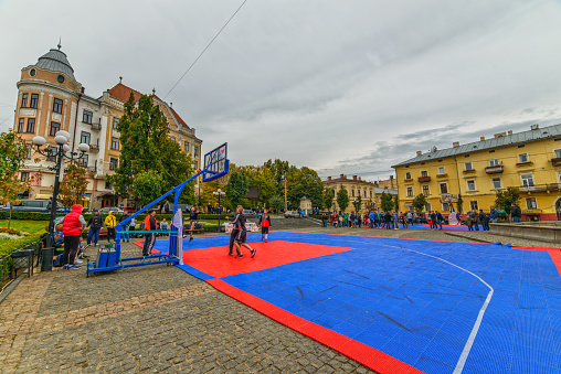 Chernivtsi, Ukraine - October 7, 2017: Street competitions in basketball. Fountain Square Philharmonic. Architecture in the old town Chernivtsi. Western Ukraine. Day of the city.