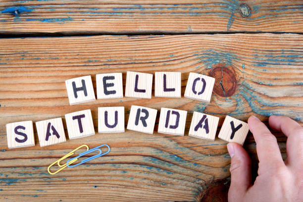 istock hello saturday. Wooden letters on the office desk 860649340