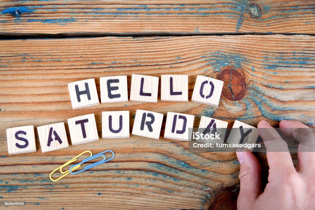 hello saturday. Wooden letters on the office desk Weekend Activities Stock Photo