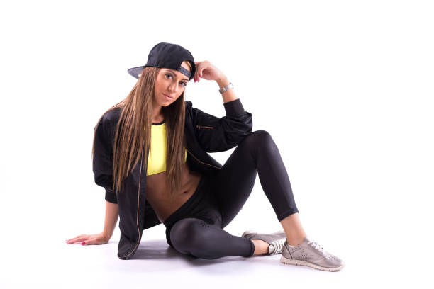 istock Stylish female hiphop dancer sitting on white background 860649344