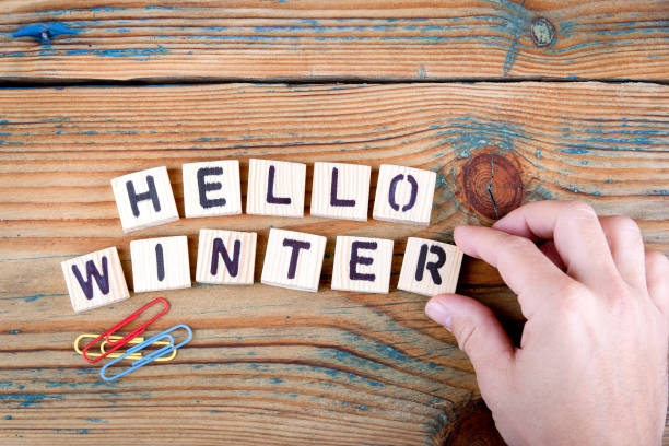 istock hello winter. Wooden letters on the office desk 860649516